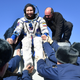 Russian space agency rescue team members help actress Yulia Peresild out from the capsule shortly after the landing of the Russian Soyuz MS-18 space capsule.